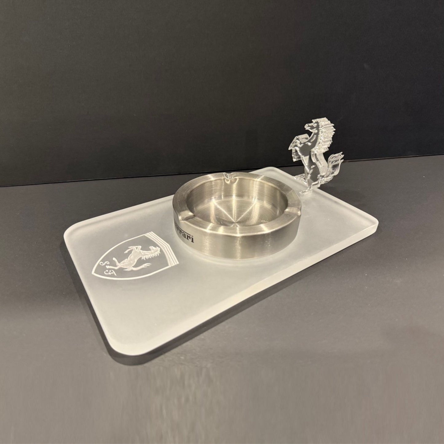 Angled perspective of a Ferrari-themed ashtray made entirely from clear and frosted acrylic, showcasing the 3D horse figure.