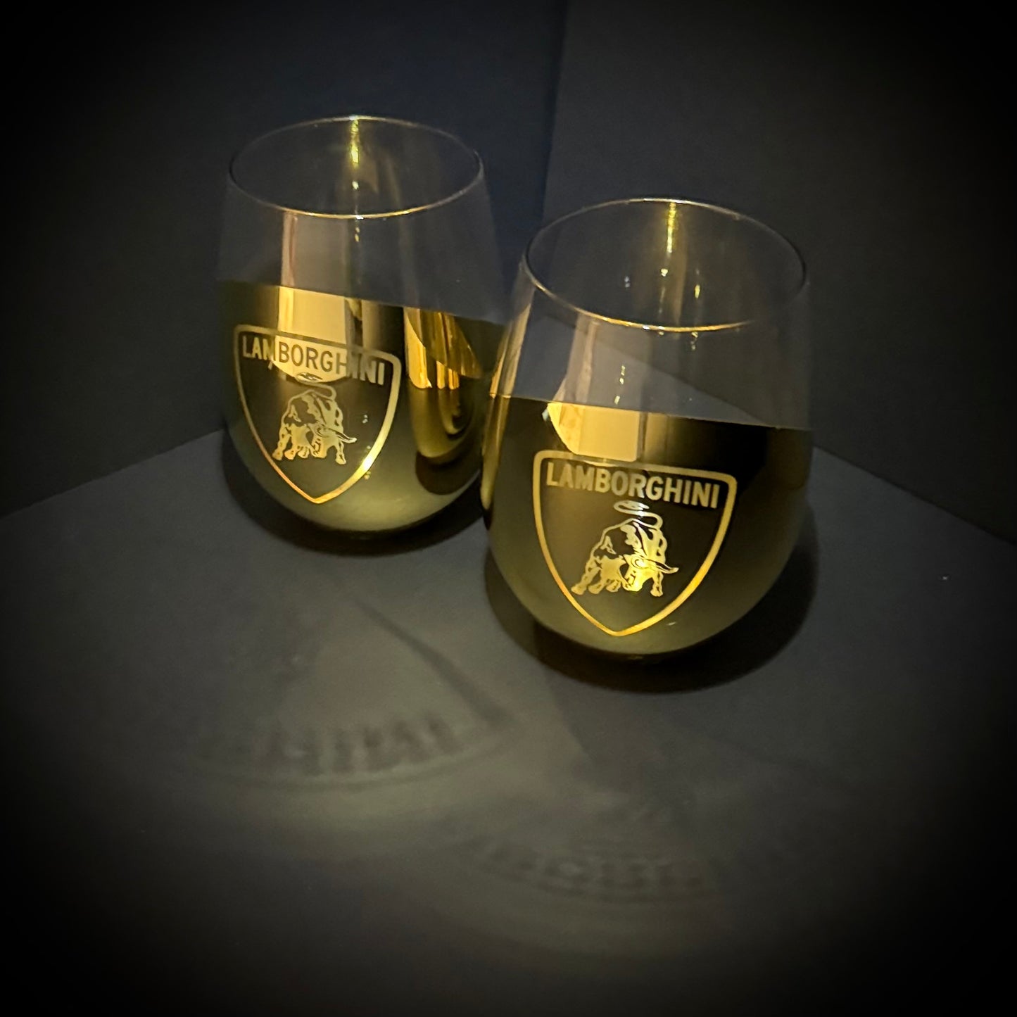 Two Golden Lamborghini-branded wine glasses