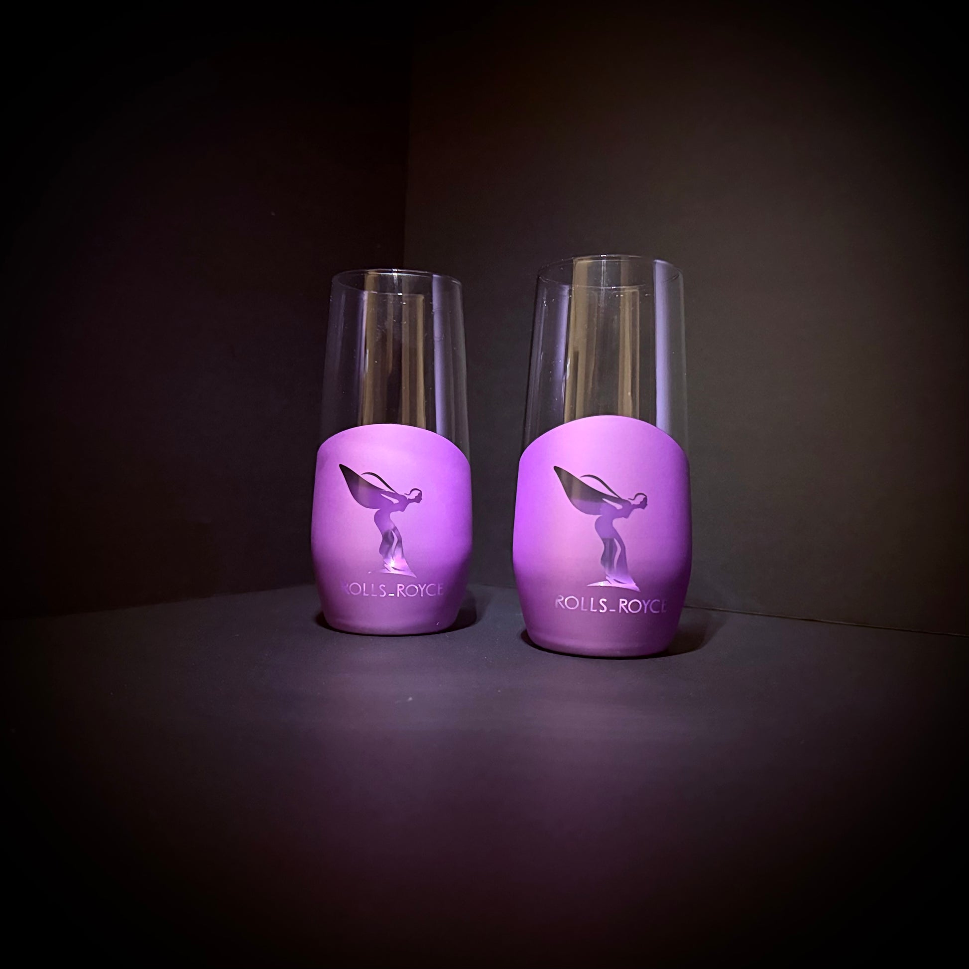 A pair of purple matte luxury glasses showcasing Spirit-inspired artwork, displayed on a dark backdrop.